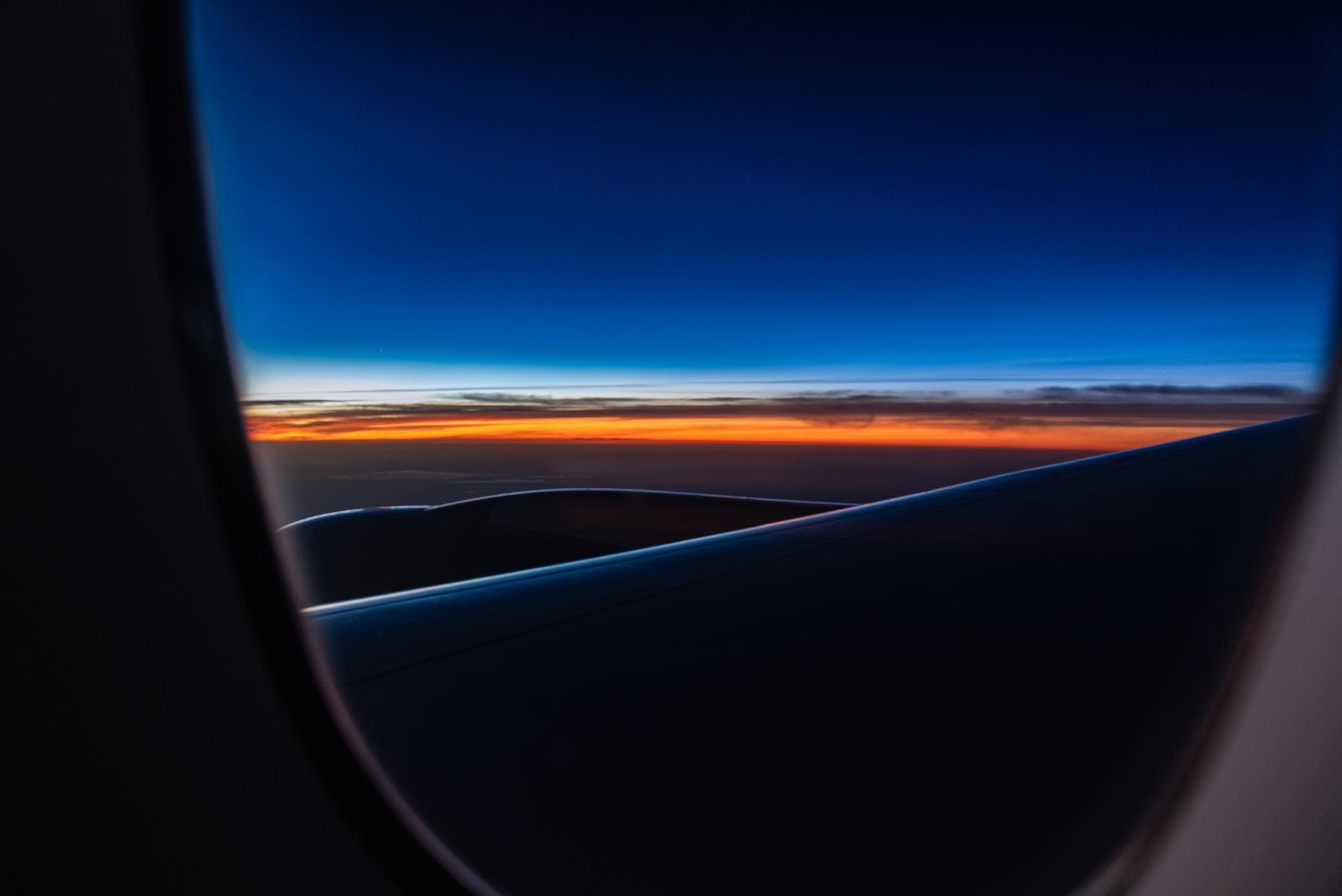 Sunset over the wing from an aeroplane window